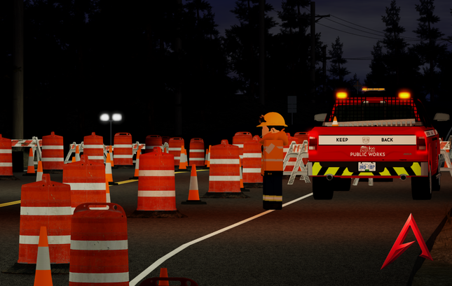 Roadwork scene with traffic cones and a Public Works truck at night.