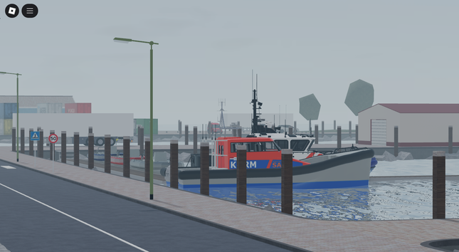 Boat docked at a pier with buildings and street signs in the background