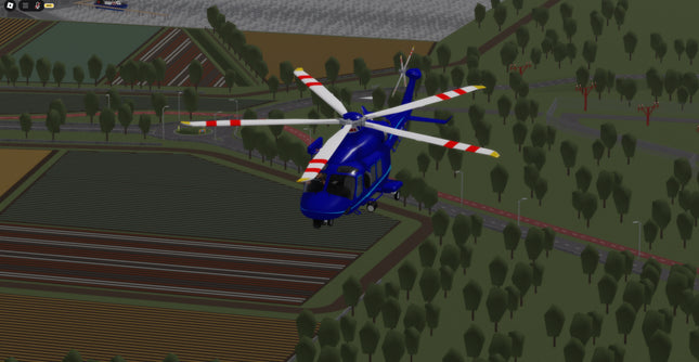 Helicopter flying over a simulated landscape with trees and roads.